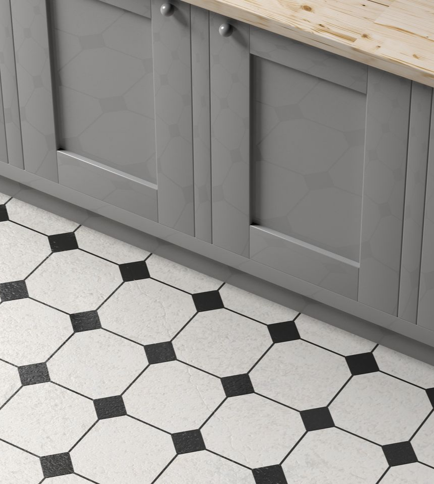 Close-up of a gray cabinet above black and white indoor floor tile.