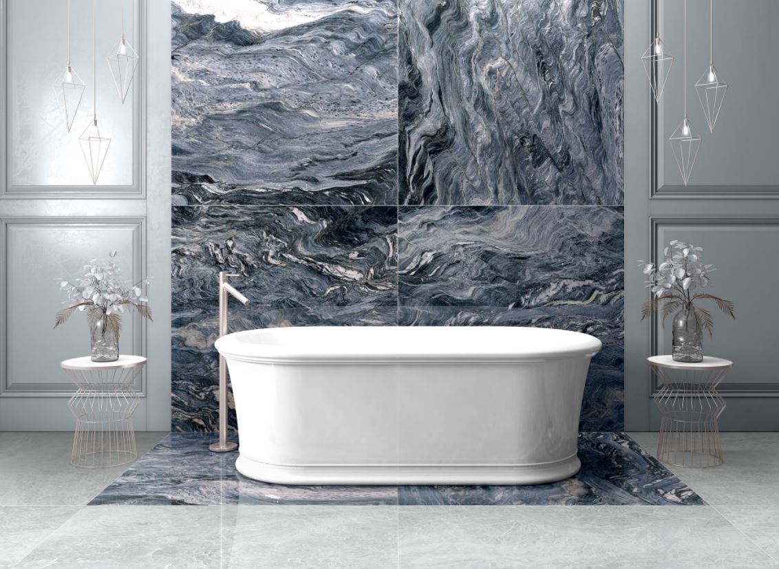 A bathroom with a bathtub and a marble wall.