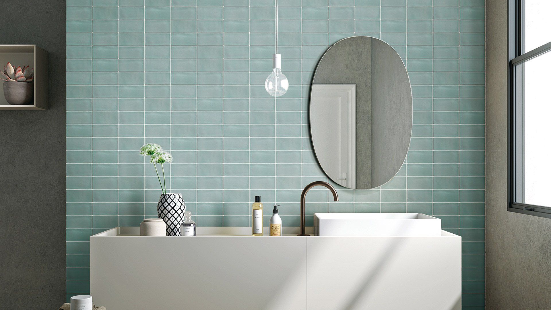 A bathroom with blue tiles , a sink , a mirror and a window | Gold Coast