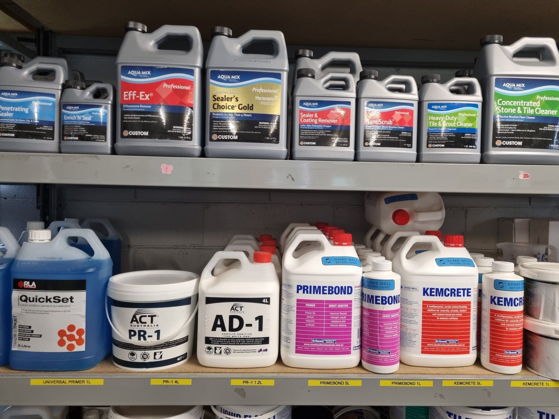 A shelf filled with lots of different types of chemicals for tiles
