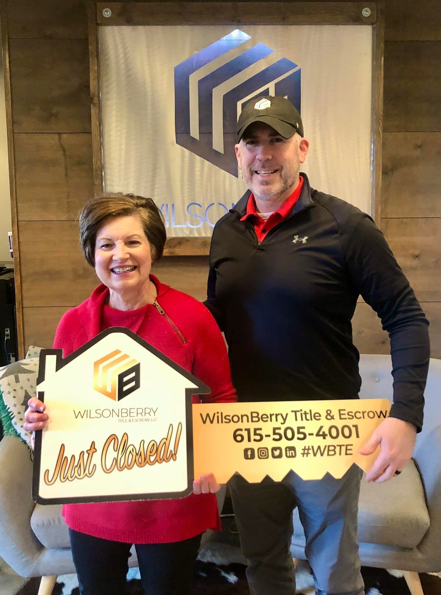 Real estate agent and client holding