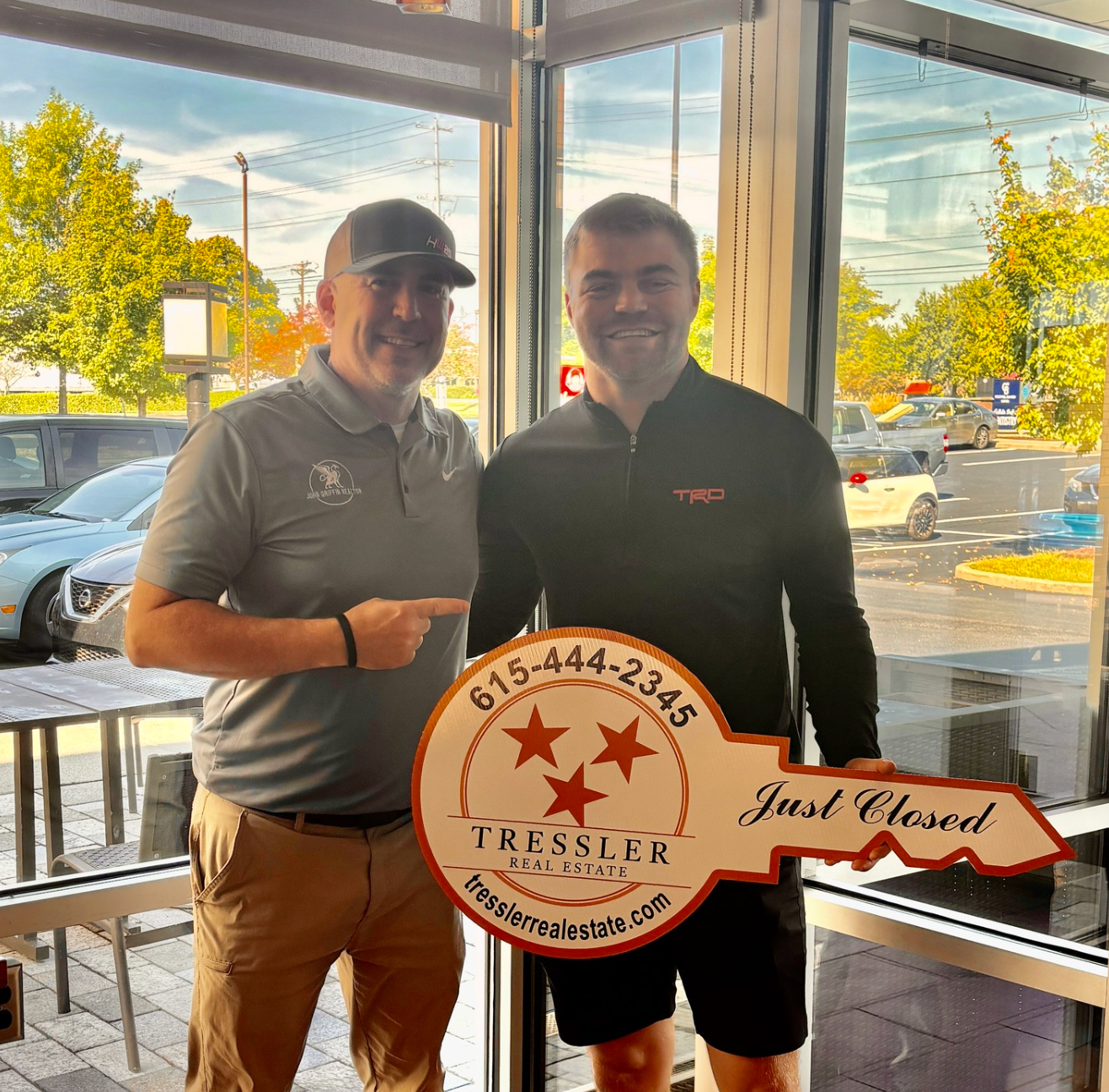 Real estate agent and clients holding