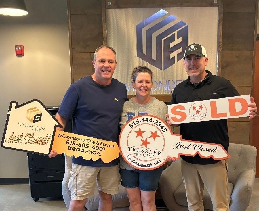 Real estate agent and client holding