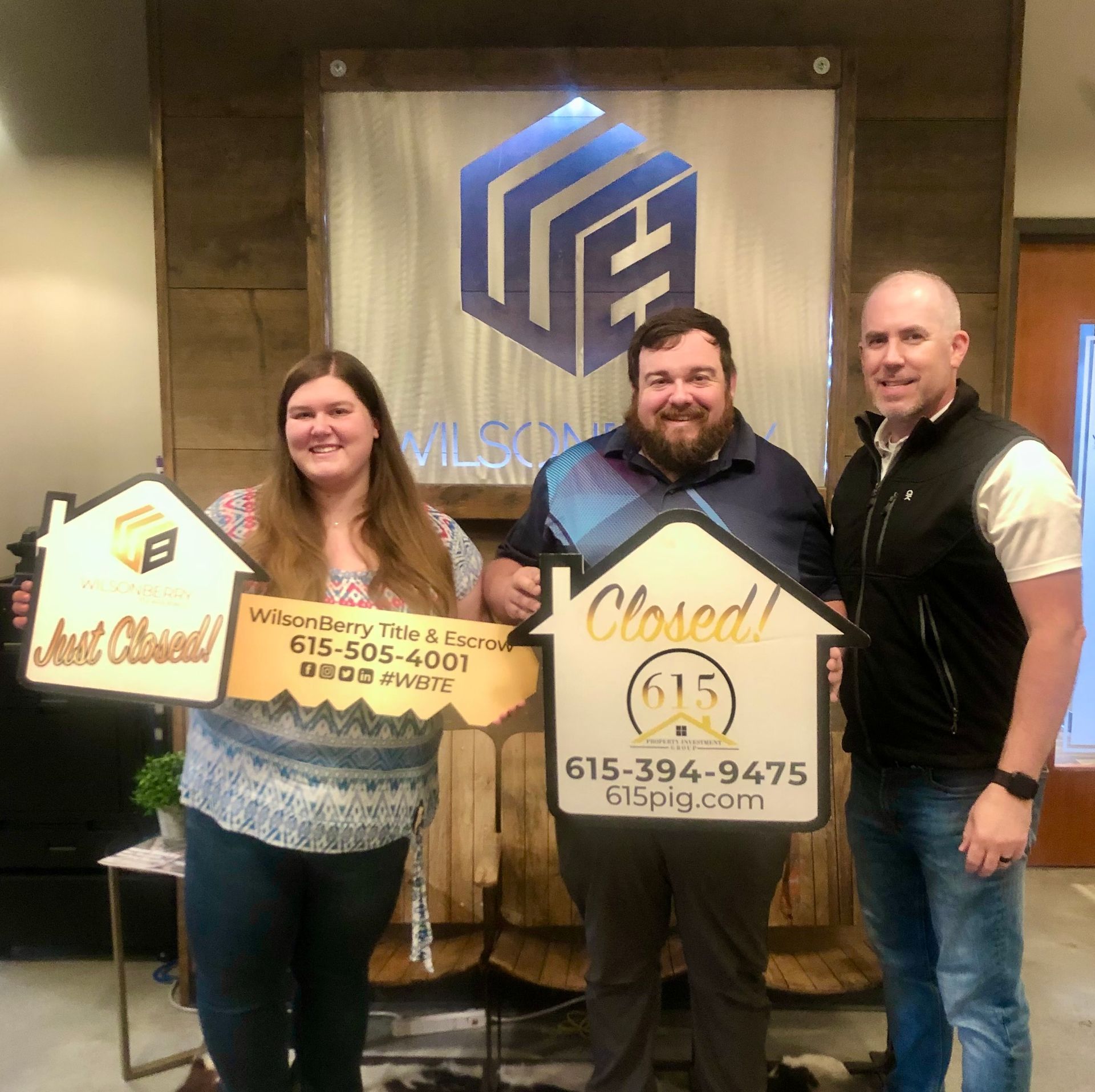 Real estate agent and clients holding