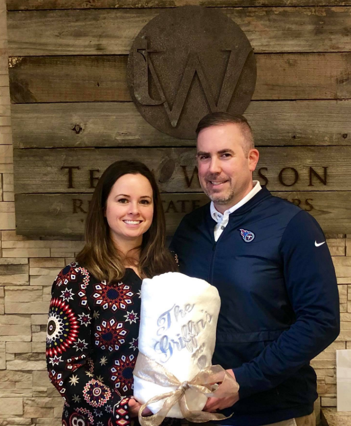 Real estate agent and client holding