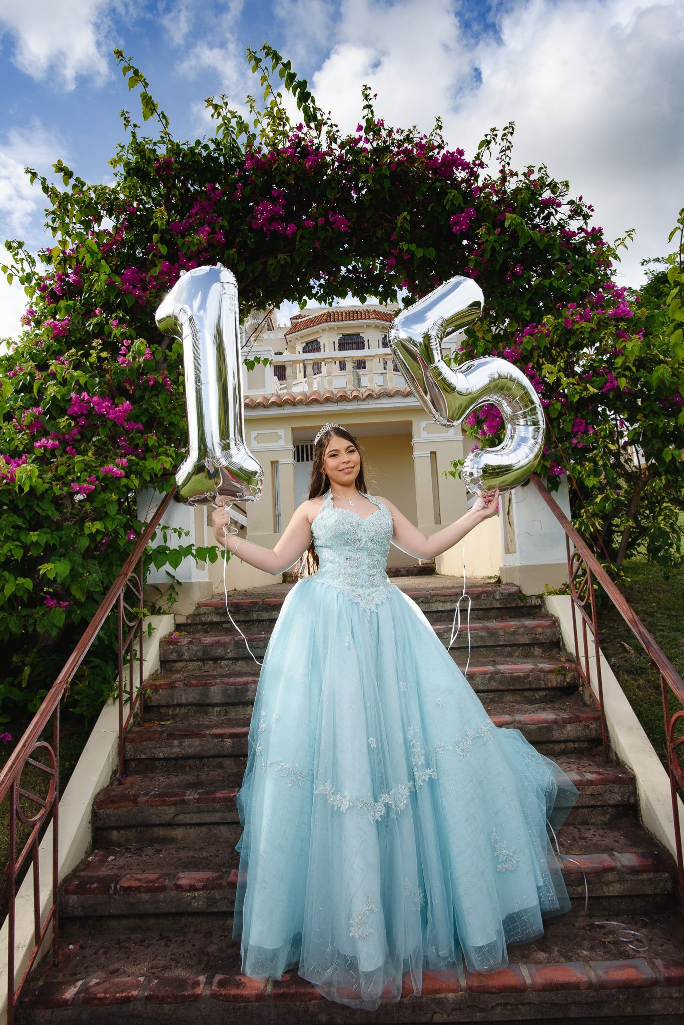Girl in blue gown holding 