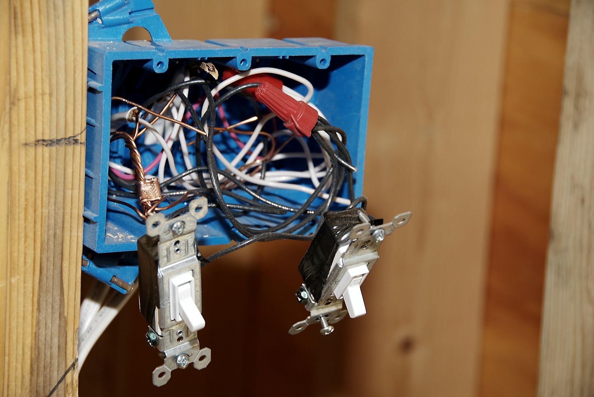 A blue box filled with electrical wires and switches.