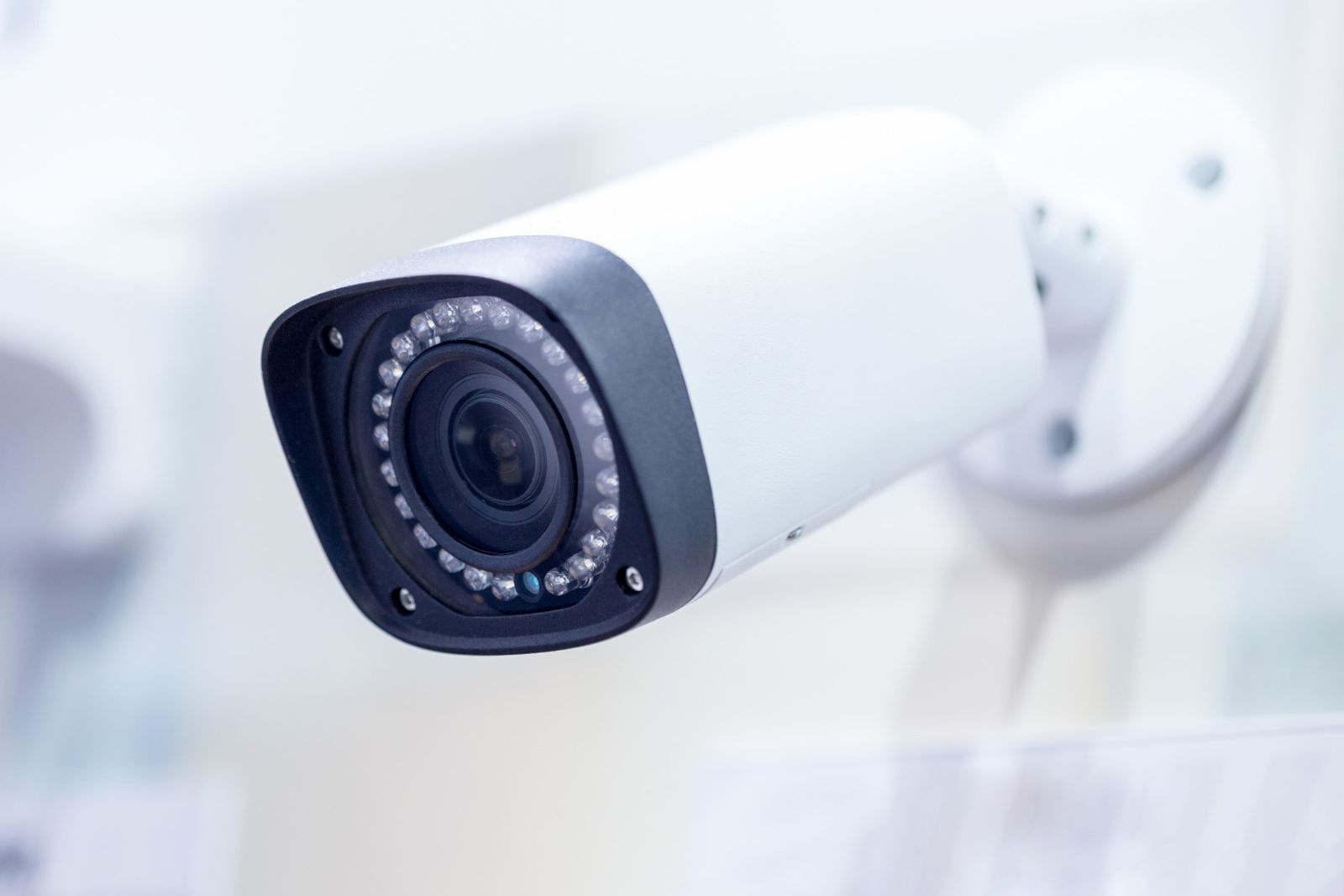 A close up of a security camera mounted on a wall.