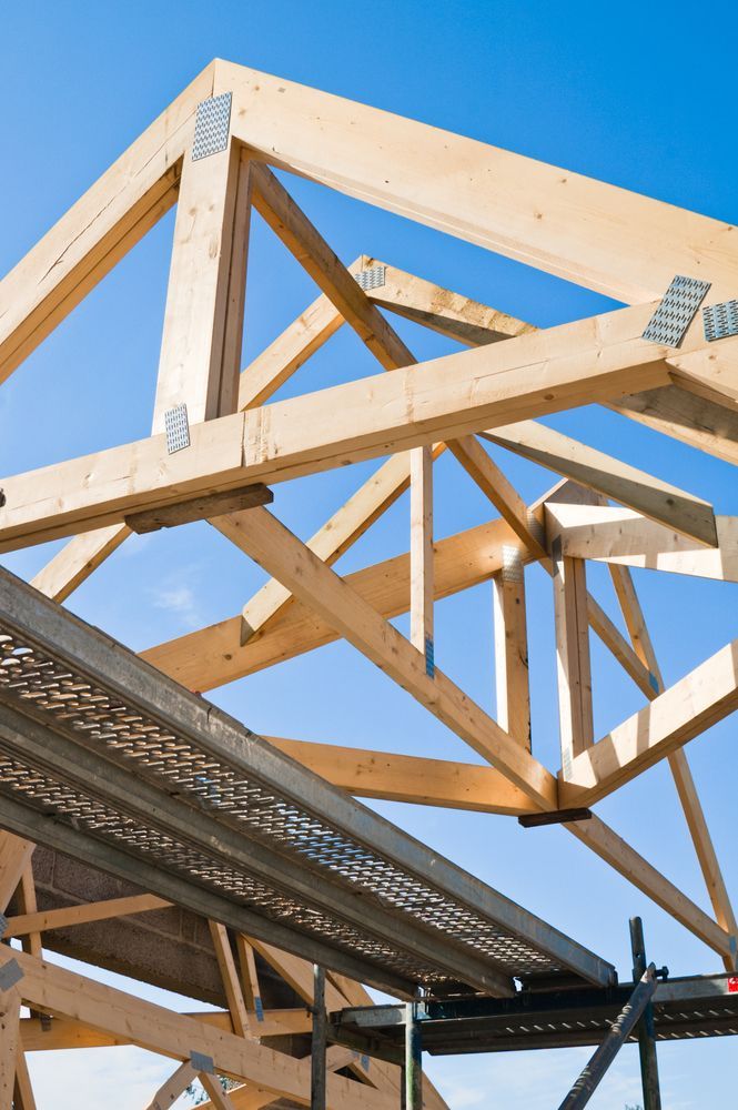 Wooden Roof Trusses Under Construction Against a Blue Sky — NRS Scaffolding Pty Ltd in Laurieton, NSW