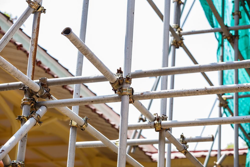 Scaffolding Structure Assembled Outside a Building With a Green Mesh — NRS Scaffolding Pty Ltd in Laurieton, NSW