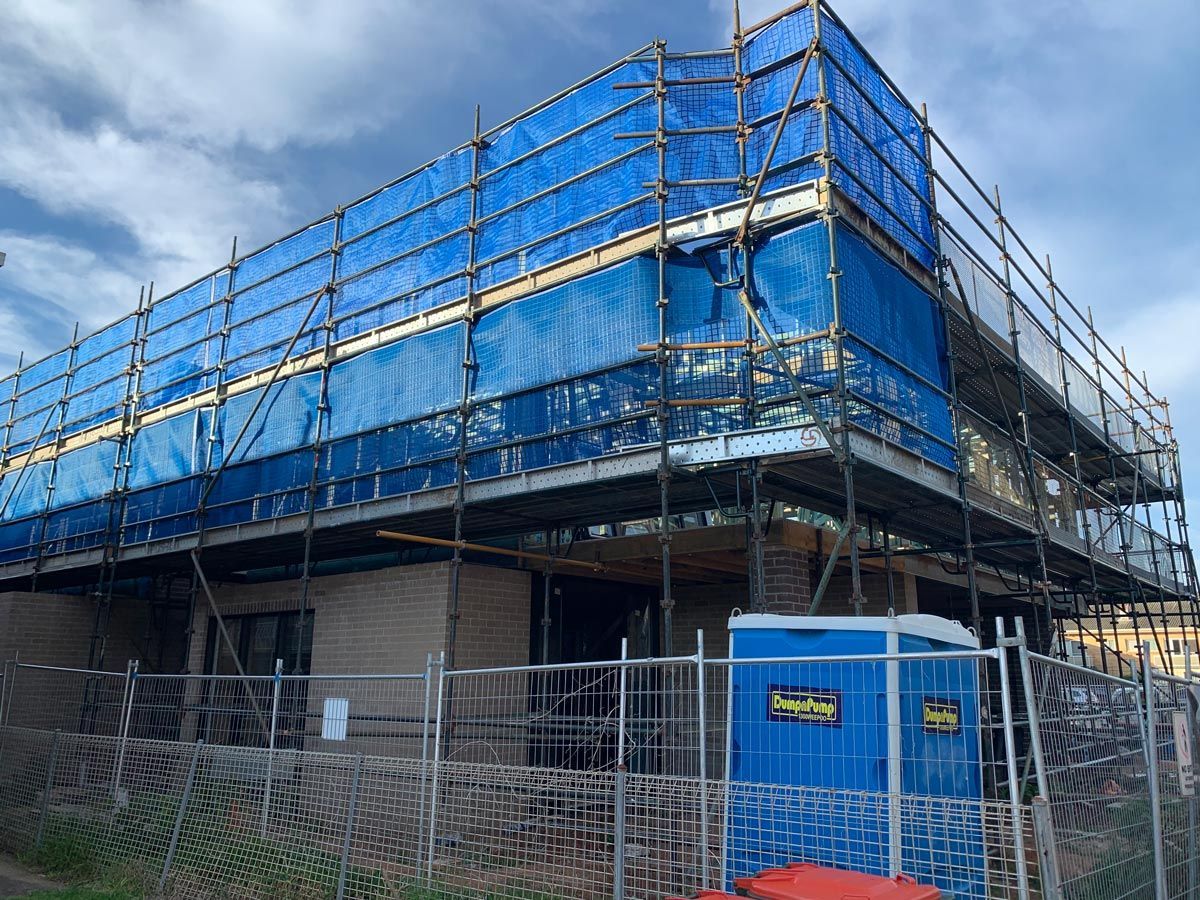 Building Under Construction, Scaffolded With Blue Safety Netting — NRS Scaffolding Pty Ltd in Forster, NSW