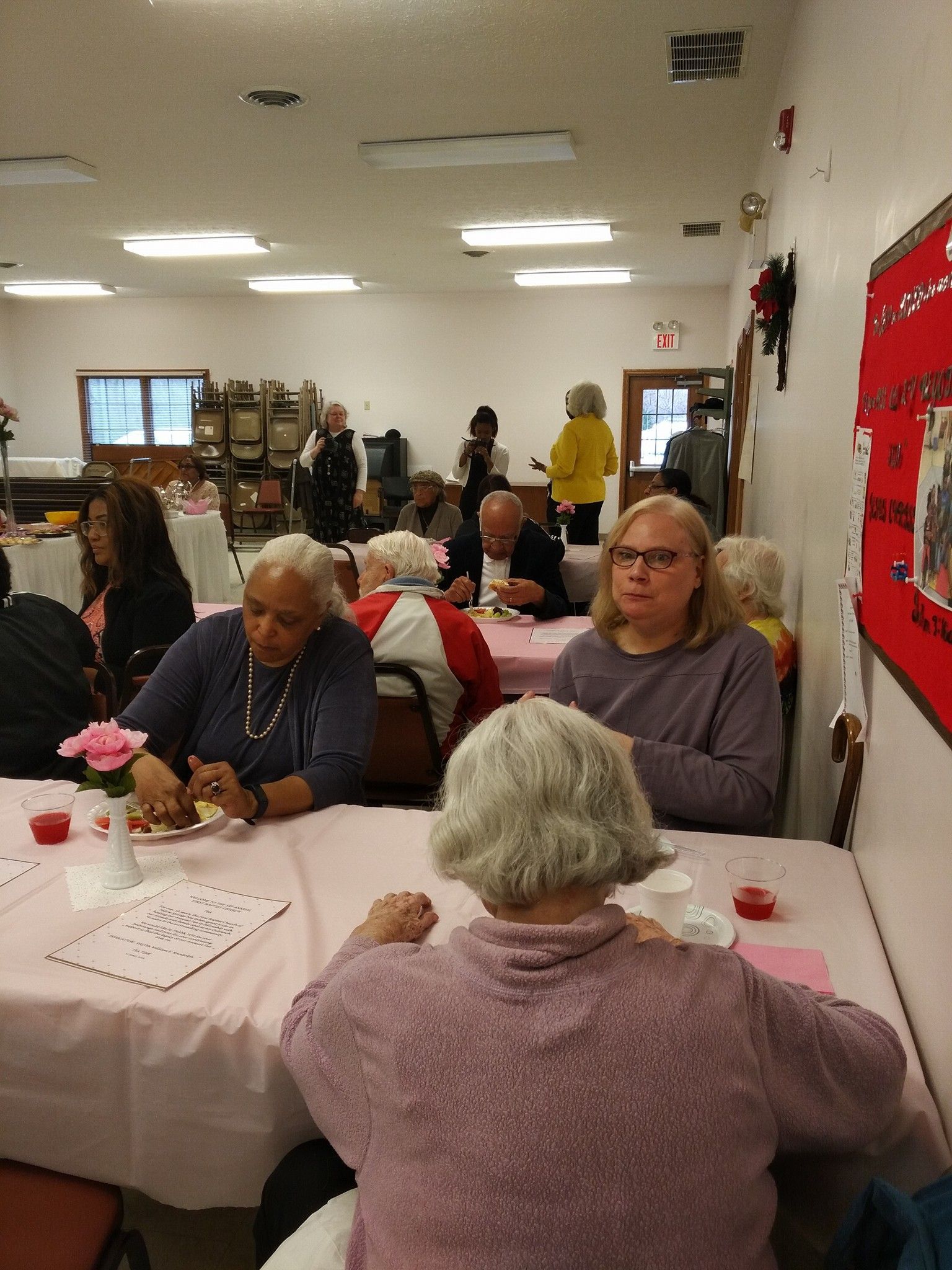 A group of people are sitting at tables in a room.