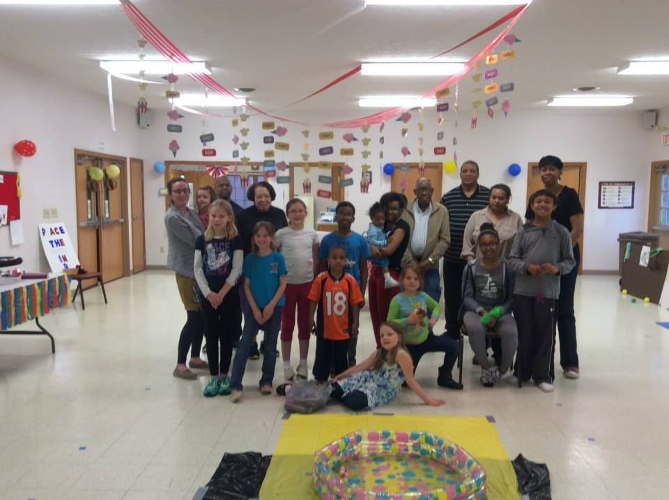 A group of people are posing for a picture in a room.