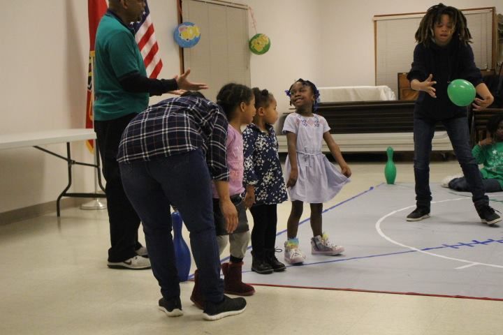 A group of children are playing with balloons in a room.