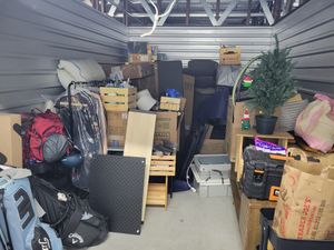 A room filled with lots of boxes and a christmas tree.