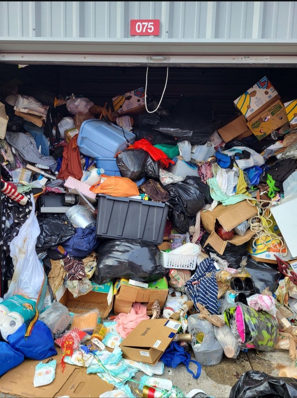 A garage filled with a lot of trash and boxes