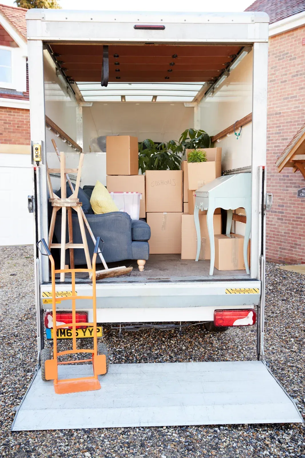 A moving truck is filled with boxes and furniture.