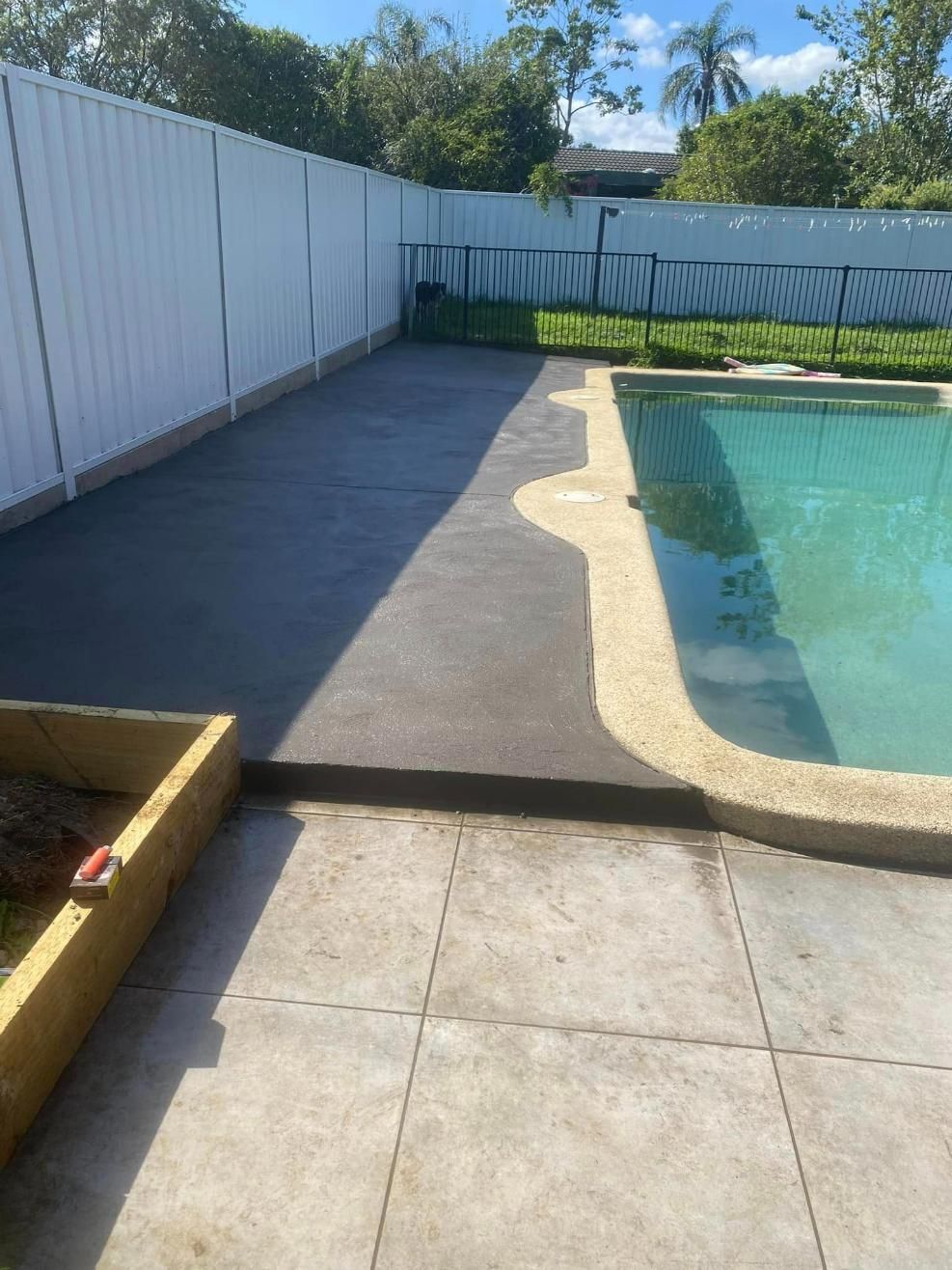 Swimming Pool is Surrounded by a Fence and a Patio — BJ's Concreting in Huskisson, NSW