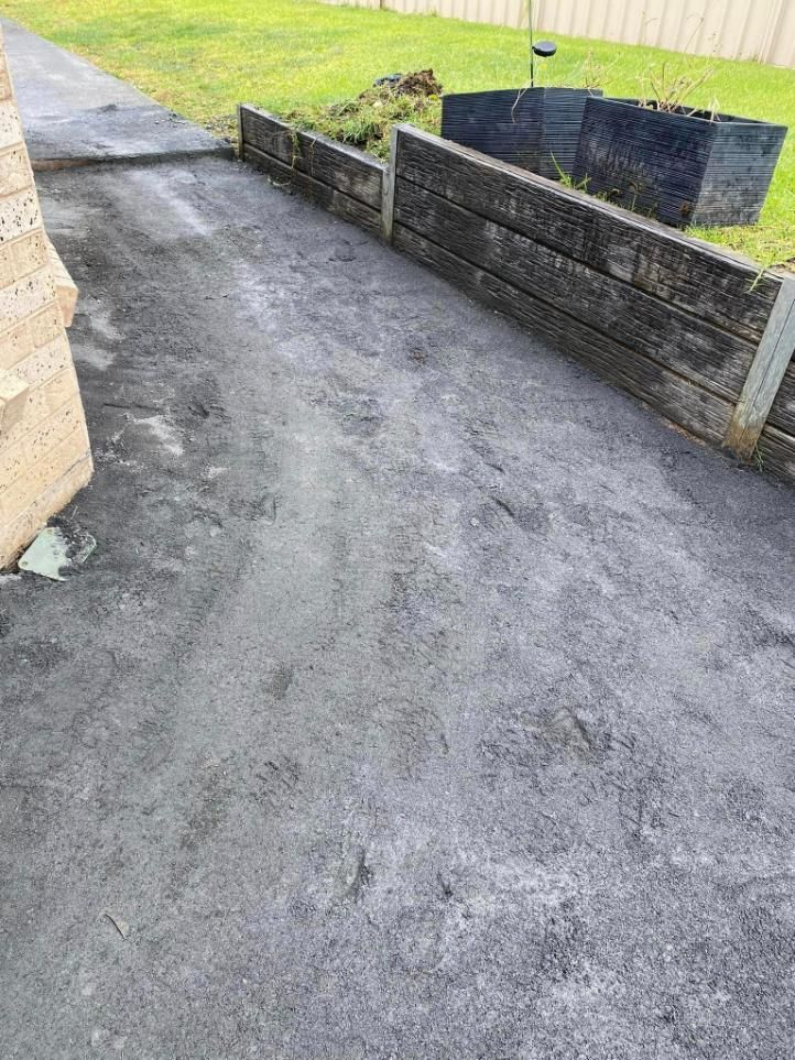 Concrete Driveway With a Wooden Fence — BJ's Concreting in Huskisson, NSW