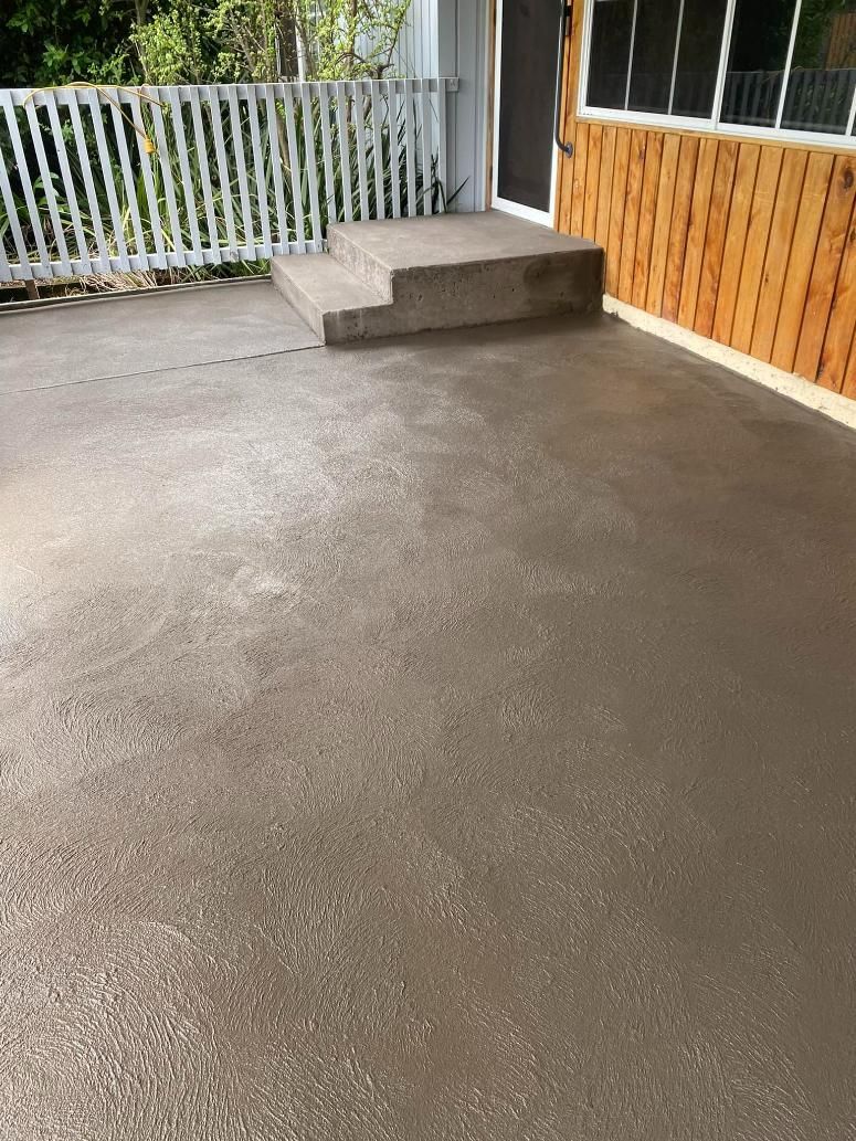 Concrete Patio With Stairs and a Wooden Fence in Front of a House — BJ's Concreting in Bomaderry, NSW