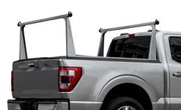 Silver pickup truck with a gray ladder rack.