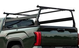 Black truck rack on the bed of a green pickup truck.