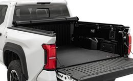 White pickup truck bed with the tailgate open and a black rolling tonneau cover.