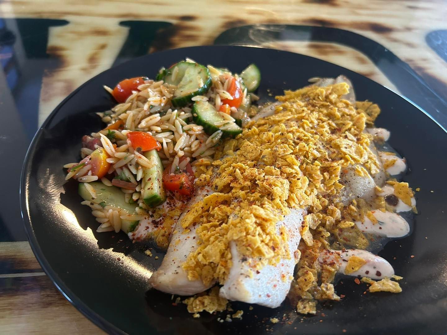 Cool Ranch Broiled Haddock topped with crumbled Doritos on a bed of tomato