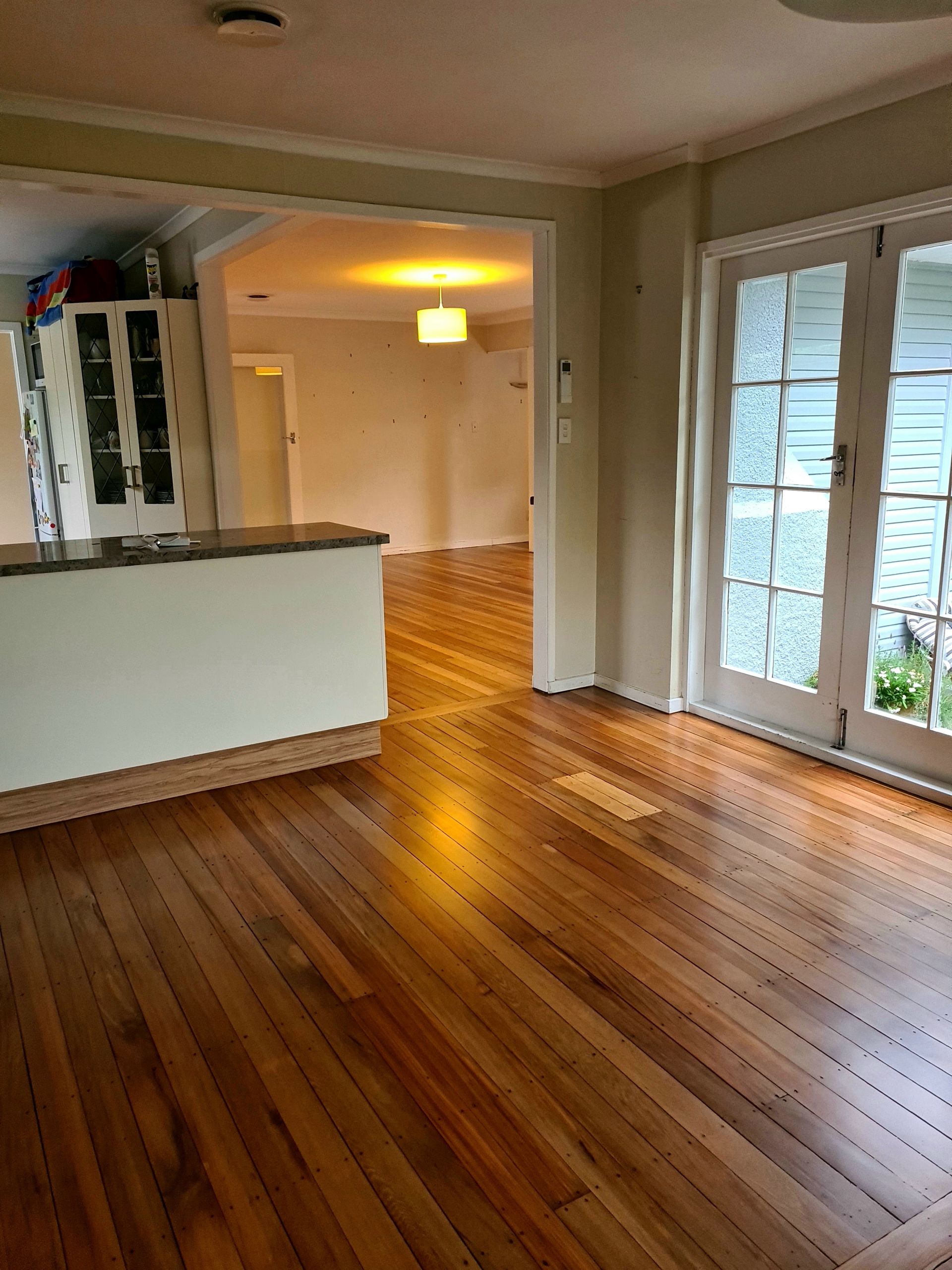 A living room with hardwood floors and french doors