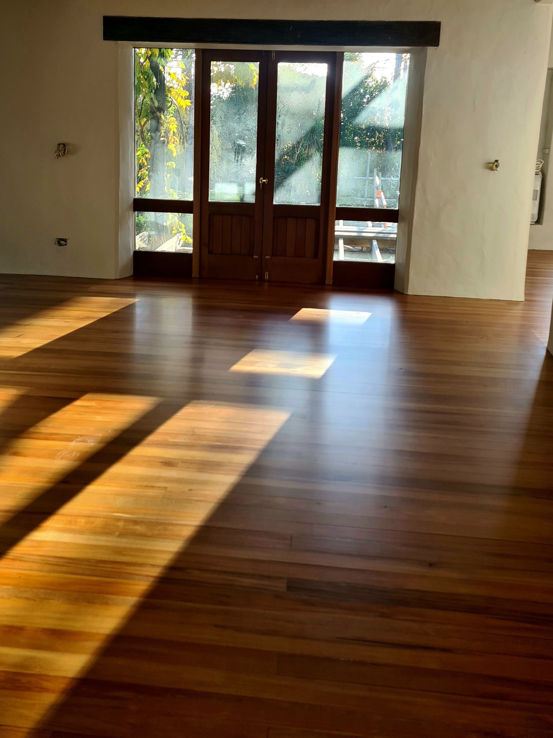 A room with a wooden floor and a window