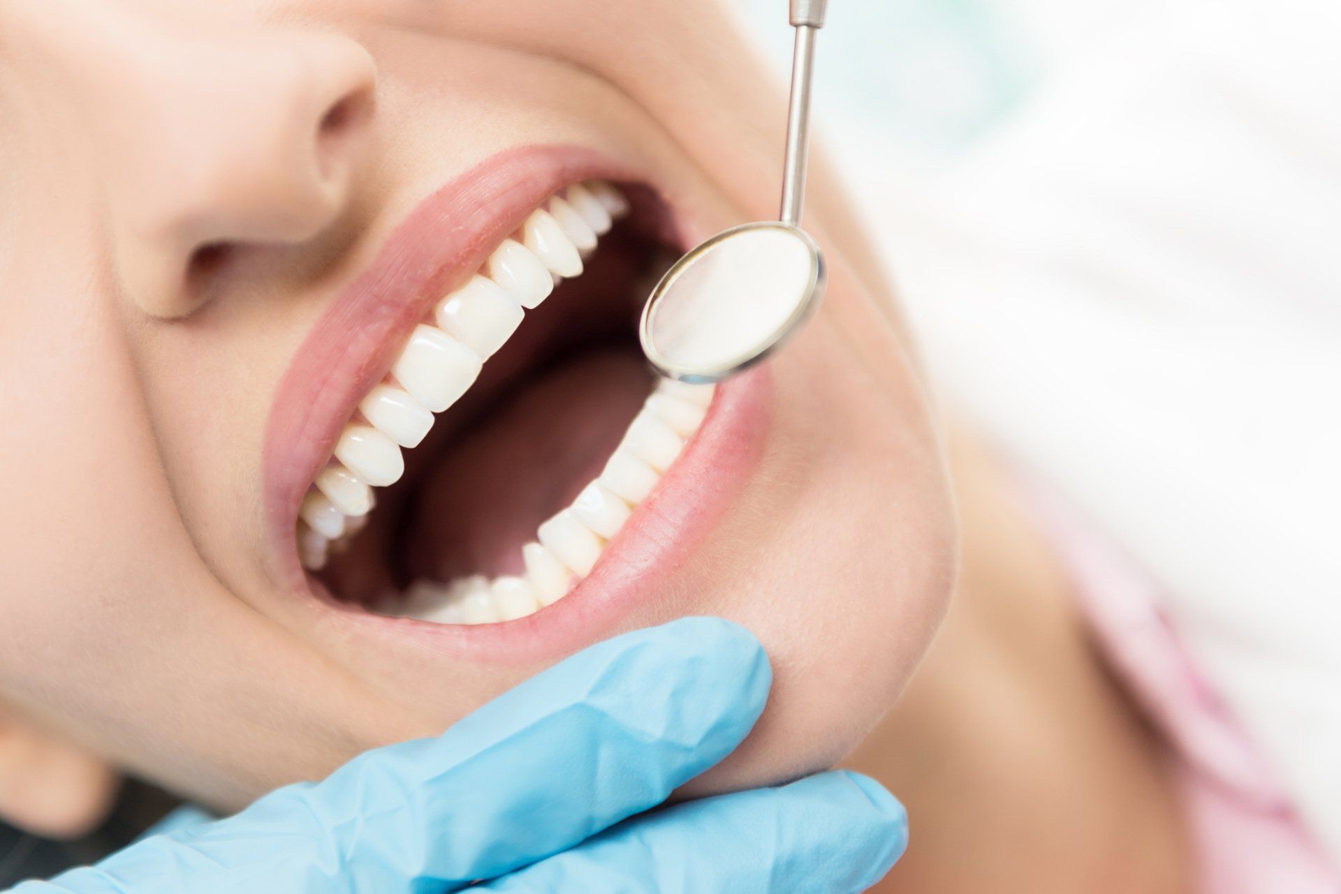 woman with healthy gums and teeth having a dental exam