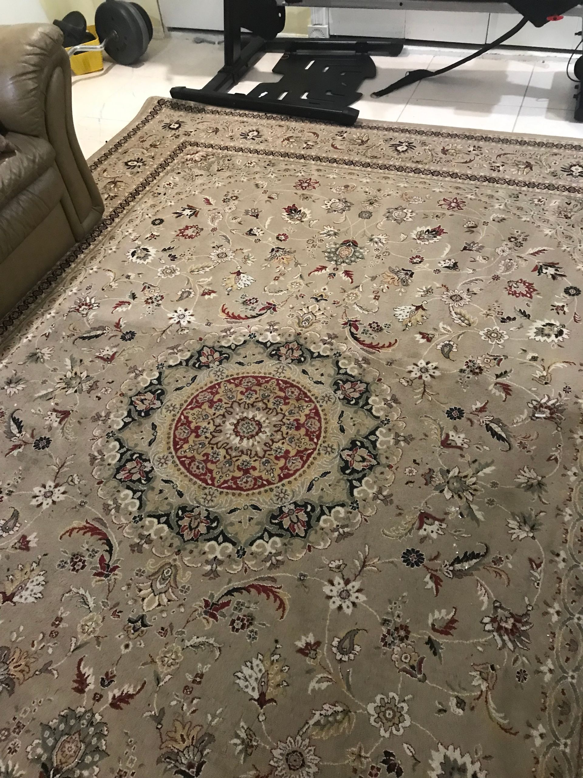 A living room with a rug and a couch.