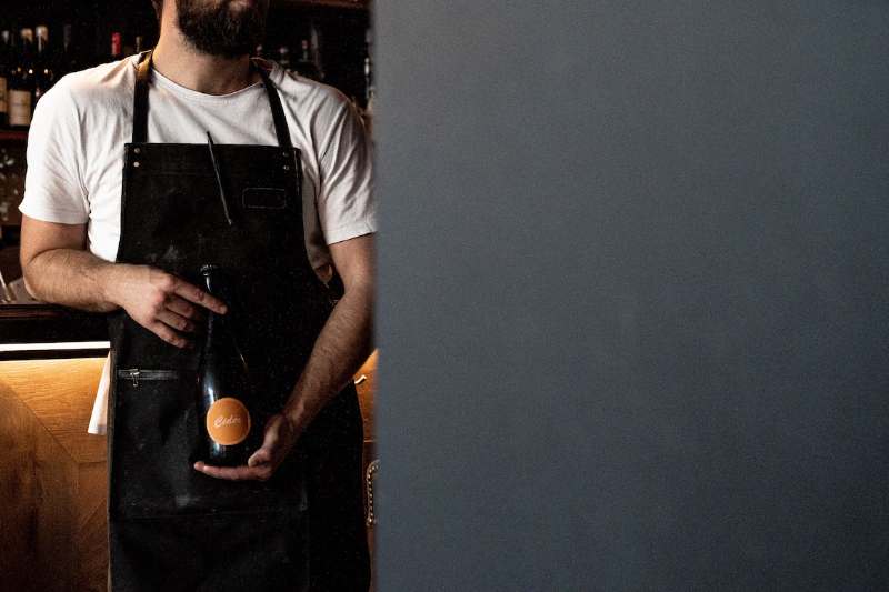 man showing wine bottle