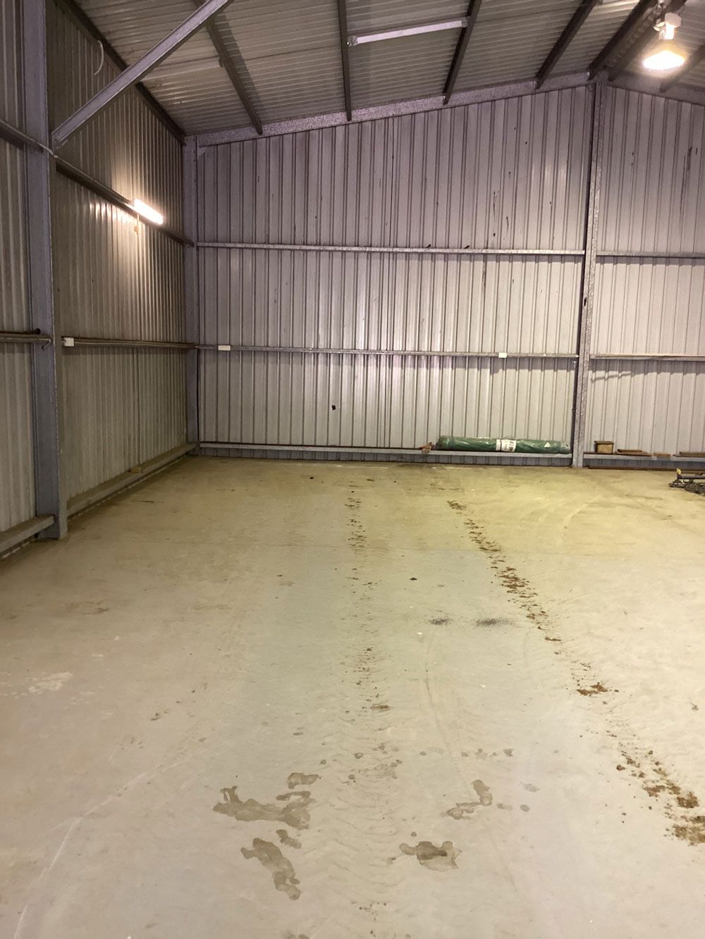 An Empty Warehouse With A Concrete Floor And A Metal Roof — Hunter Valley Caravan Storage in North Rothbury, NSW