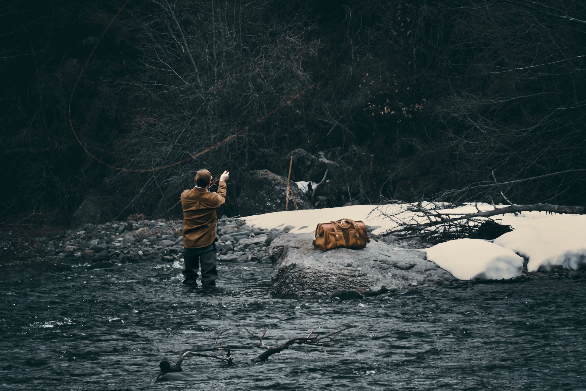 ATLATL Media photography of man fly fishing in river.