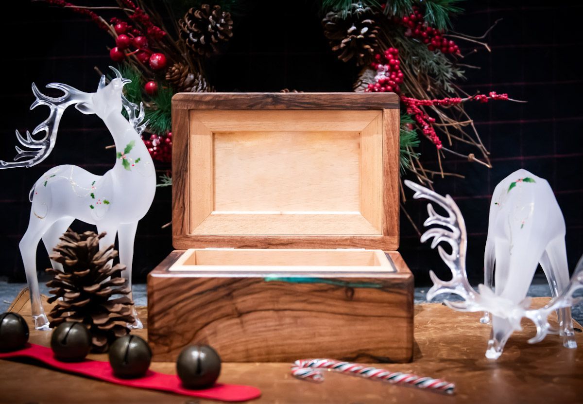Wooden chess set on a wooden shutter. Blue and gold board with white and blue pieces.