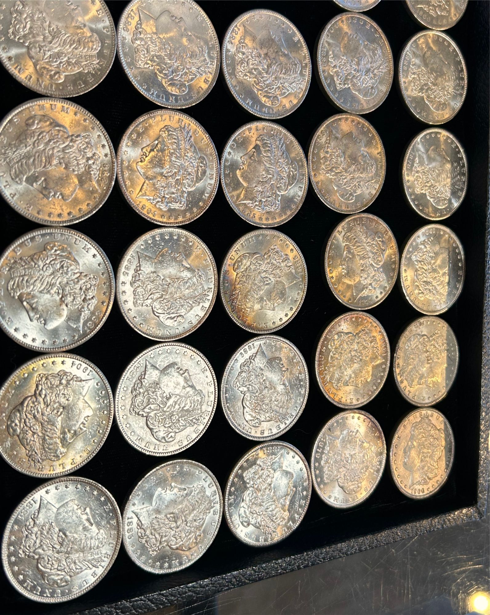 A person is holding a one pound coin between their fingers