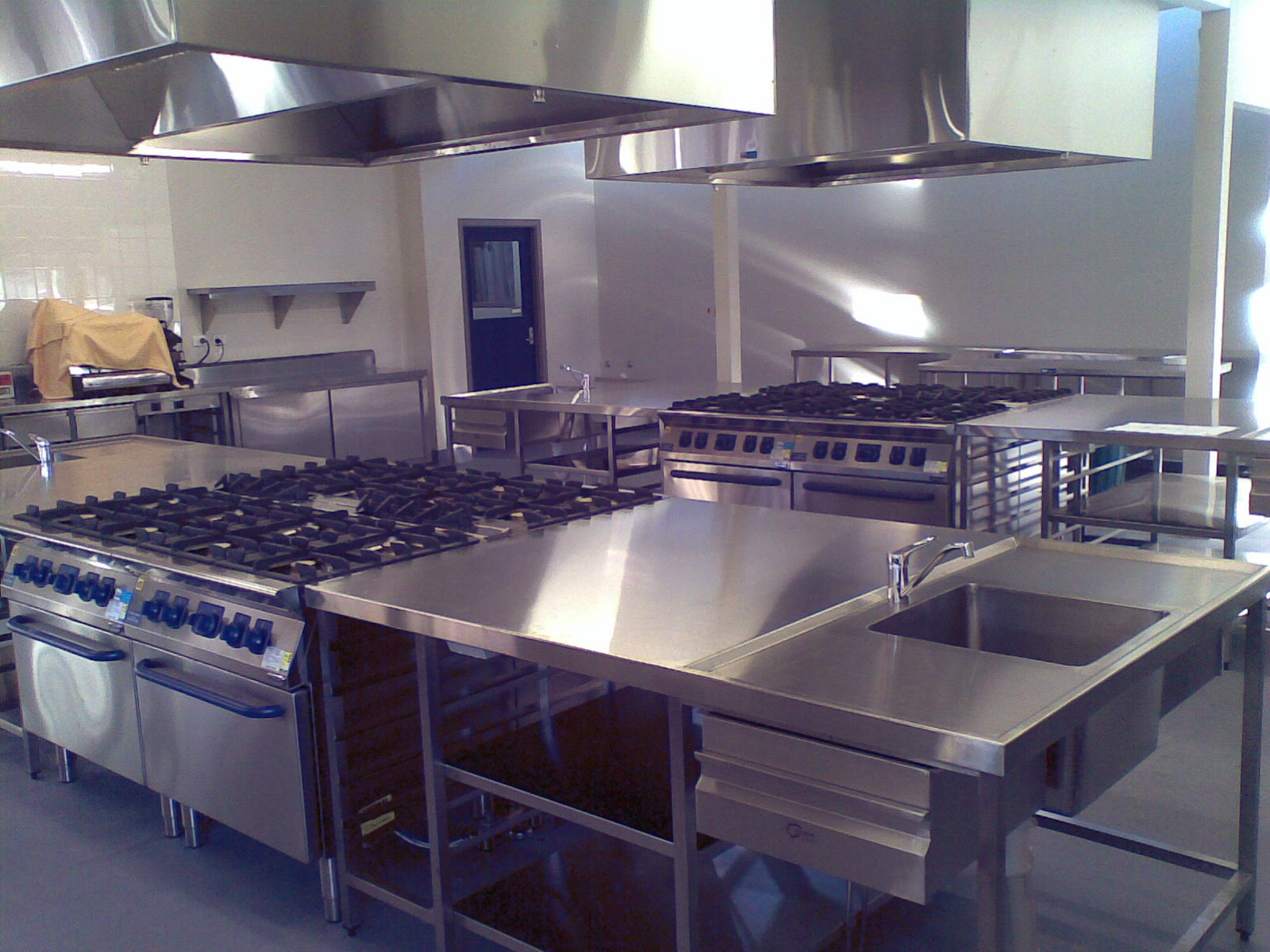 A kitchen with stainless steel appliances and a sink