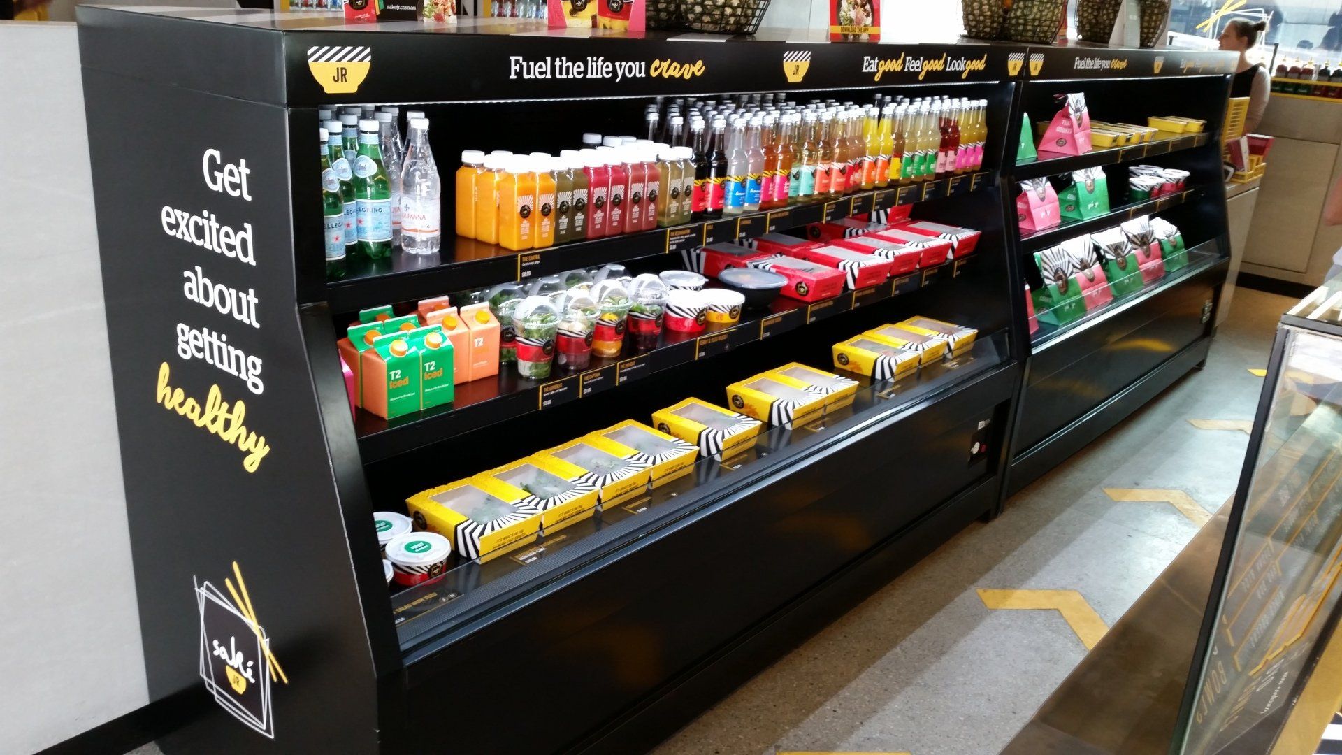 A display case with a sign that says get excited about eating healthy
