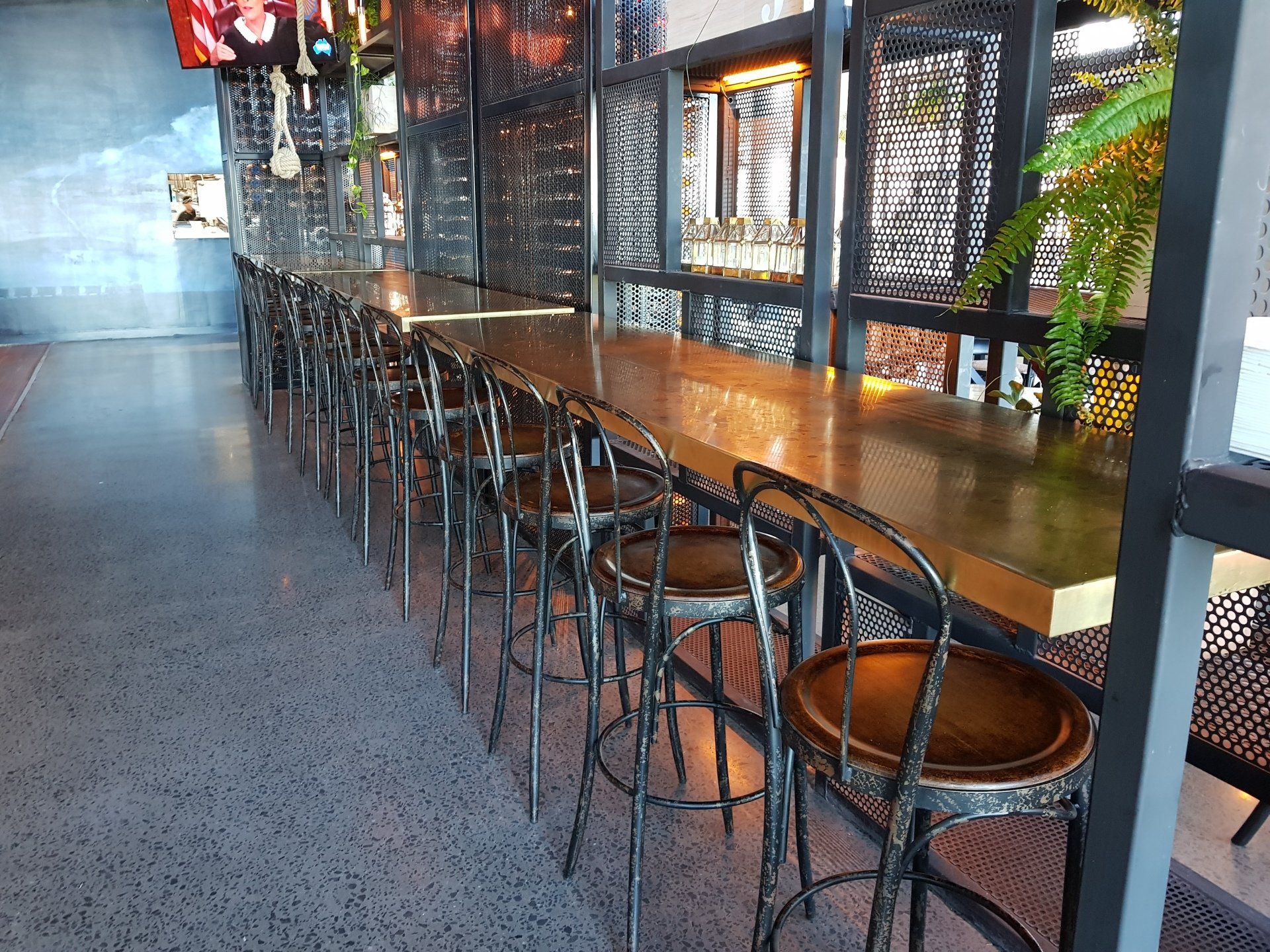 A long table with a lot of chairs in a restaurant
