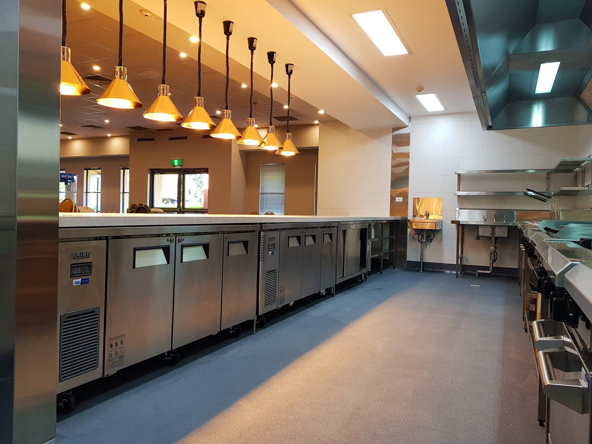 A large kitchen with stainless steel cabinets and appliances