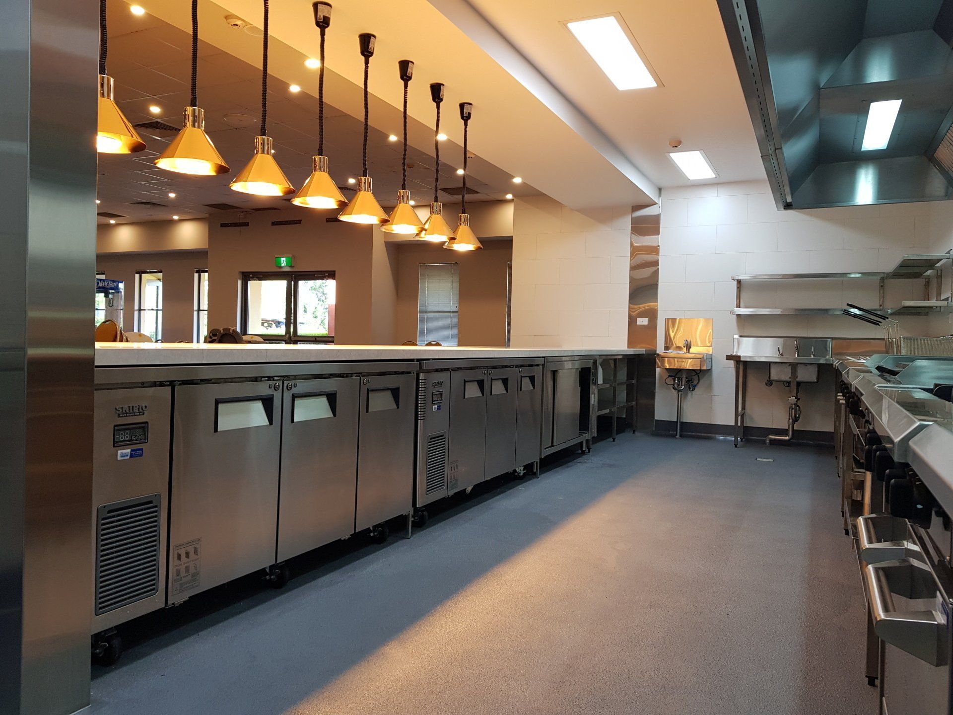 A large kitchen with a lot of stainless steel appliances