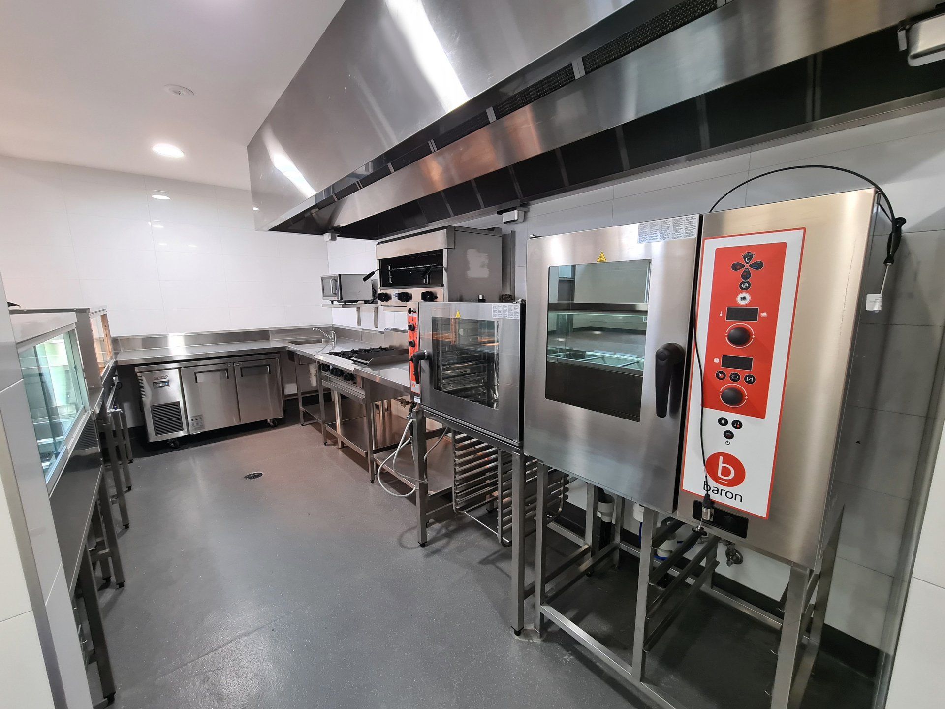A large kitchen with a lot of stainless steel appliances.
