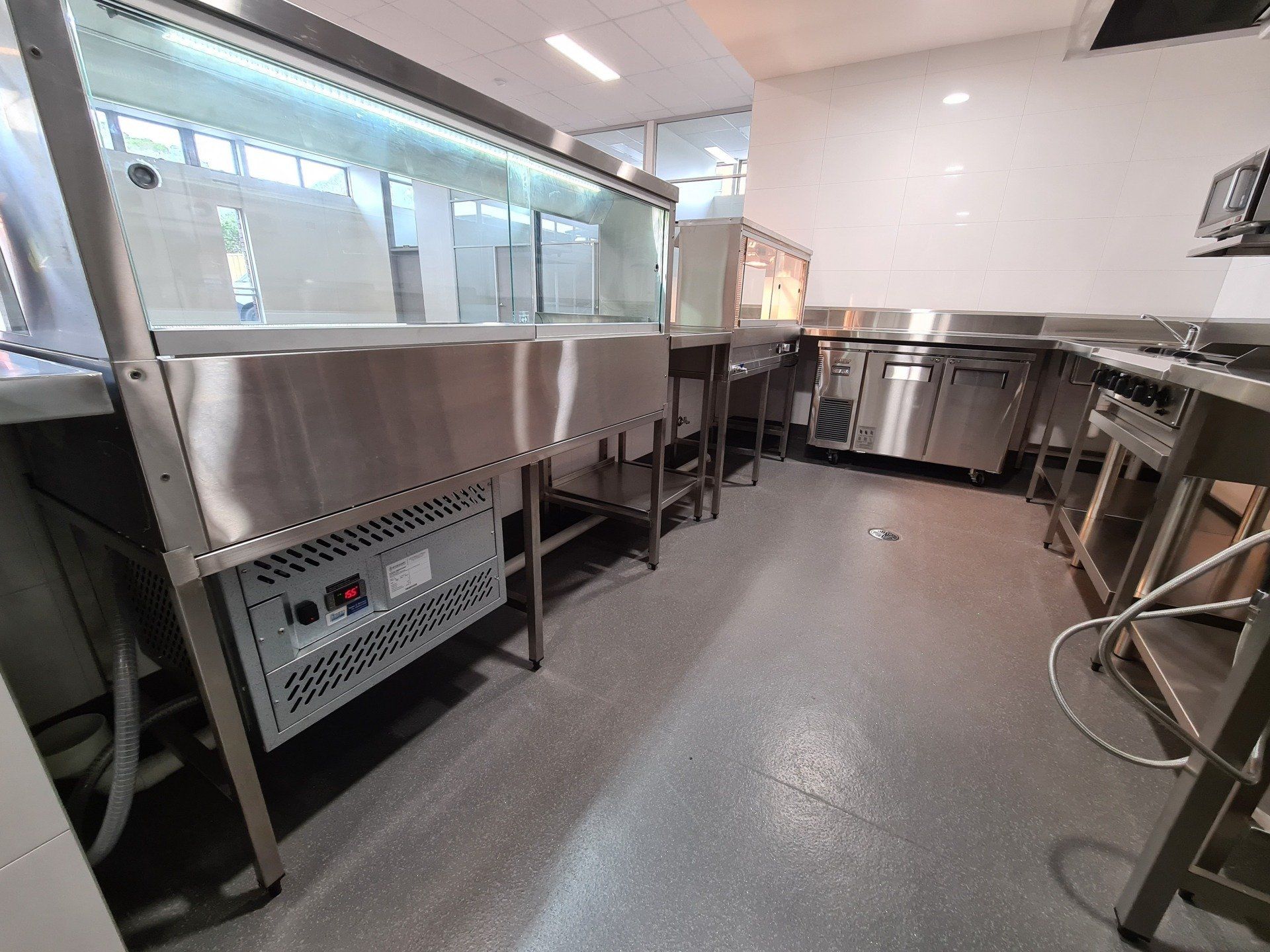 A large kitchen with a lot of stainless steel appliances.