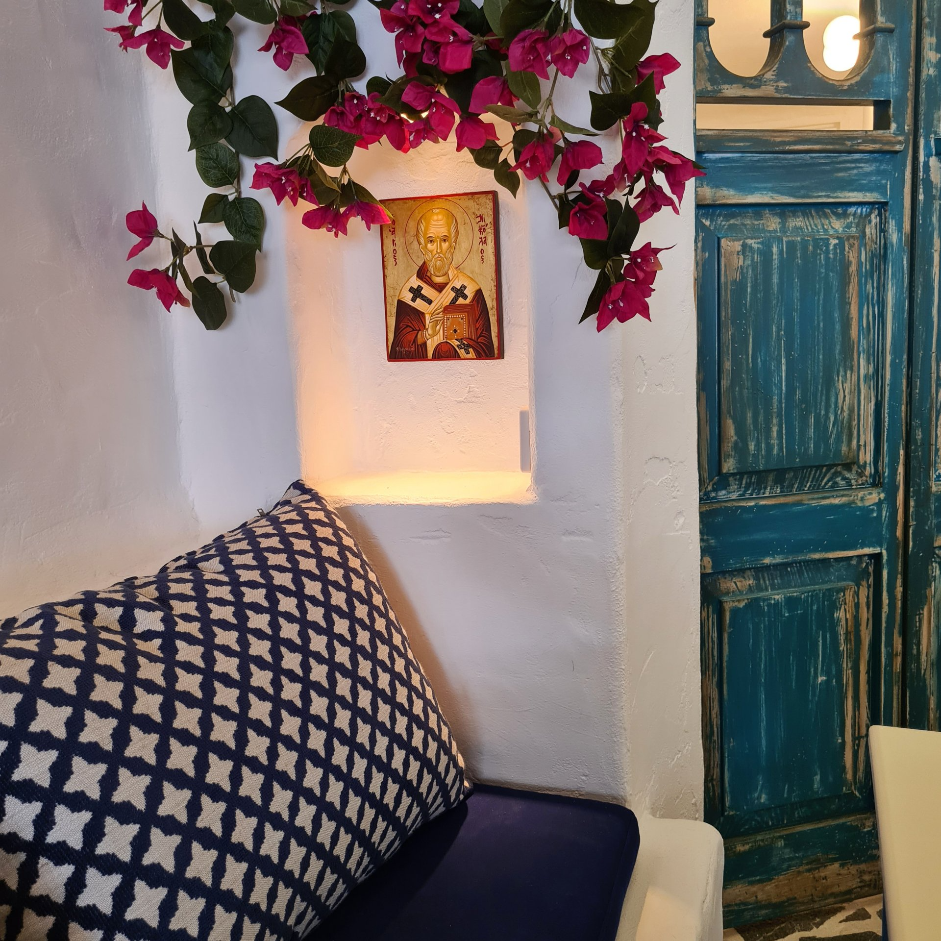 A room with a blue door and a picture on the wall