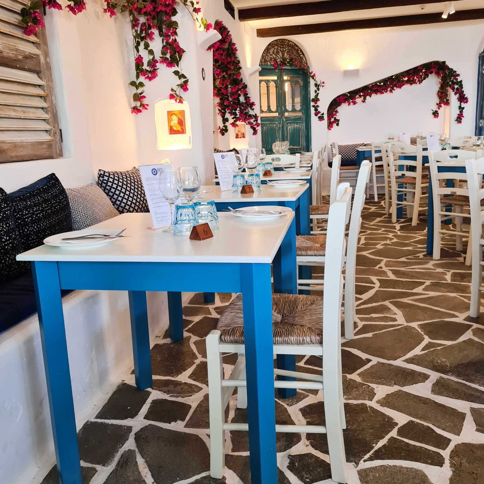A restaurant with blue and white tables and chairs
