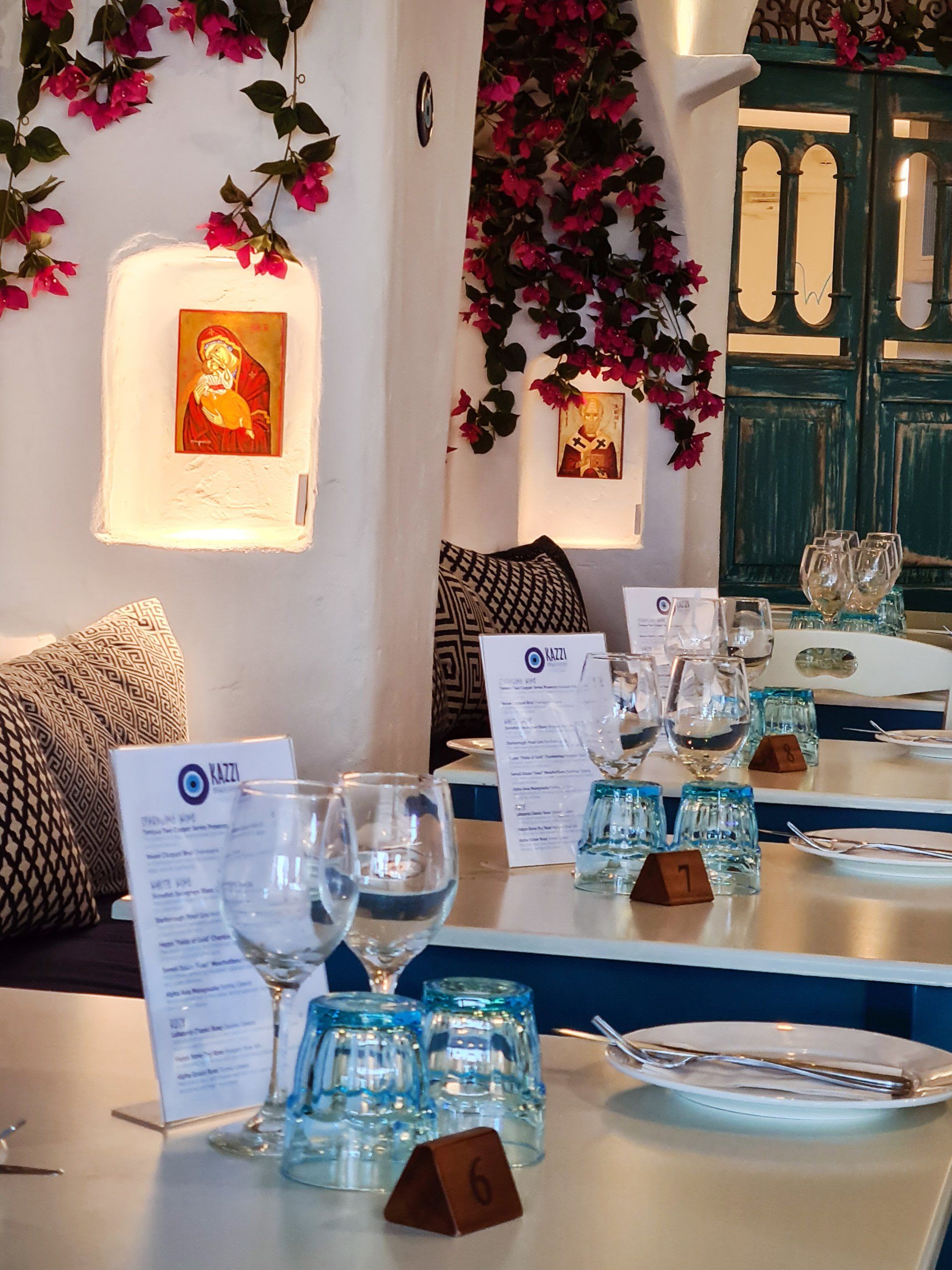 A restaurant with tables set up with plates and glasses and a sign that says ' a ' on it