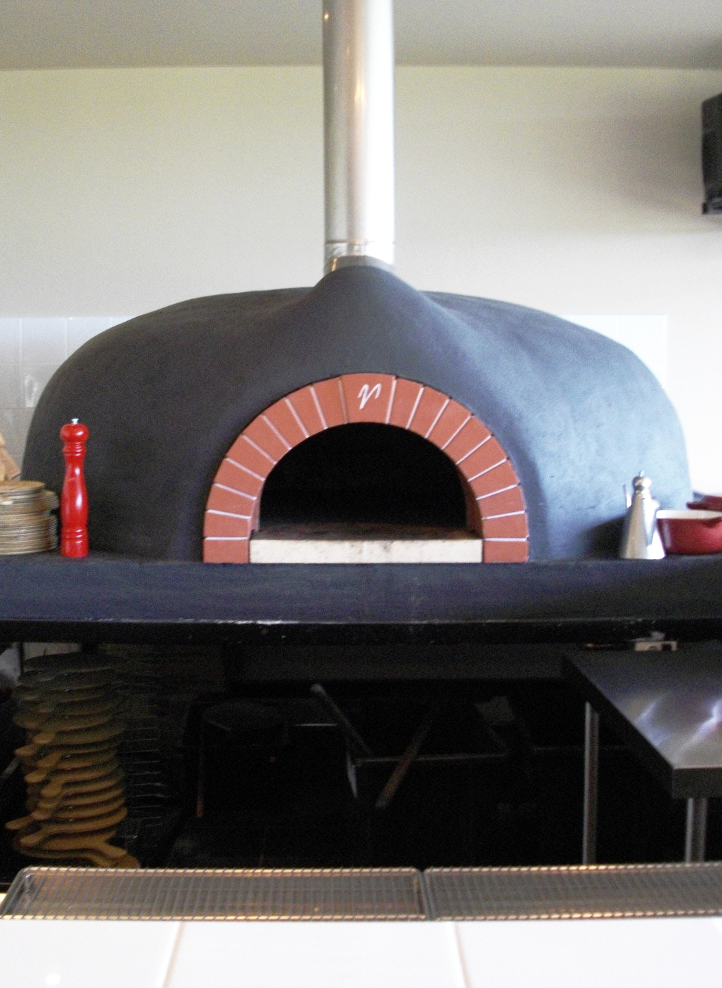 A pizza oven with the letter f on it