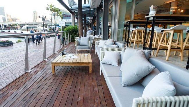 A wooden deck with a lot of furniture on it