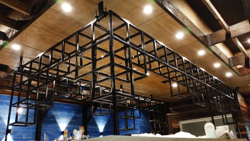 A restaurant with a wooden ceiling and a metal frame.